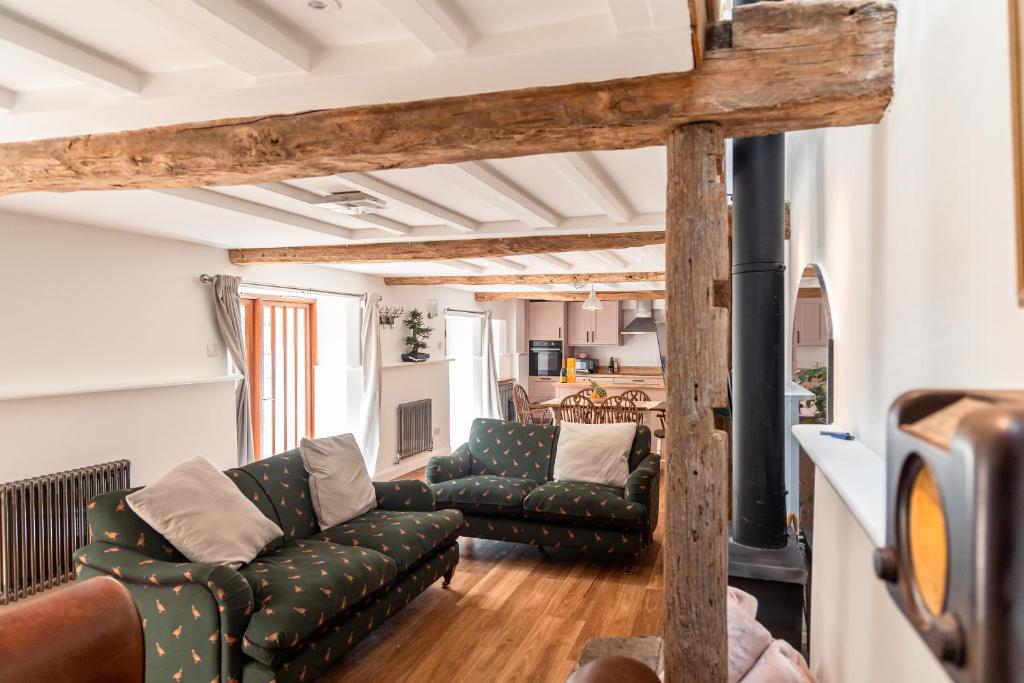 a living room with two couches and a fireplace at West Town Barn in Exeter