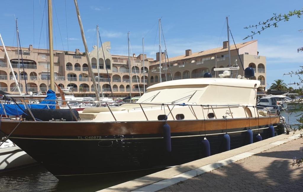 a boat is docked at a dock in a harbor at La Cigale Varoise - Hyères La Plage in Hyères
