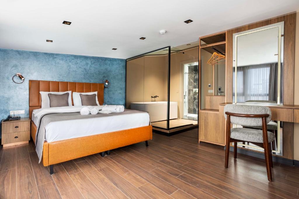 a bedroom with a bed and a desk and a bathroom at Marlon Hotel in Istanbul