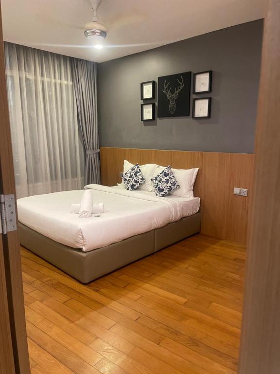 a bedroom with a bed with two pillows on it at Vortex Suites Klcc 2bedroom & 3bedroom apartment in Kuala Lumpur