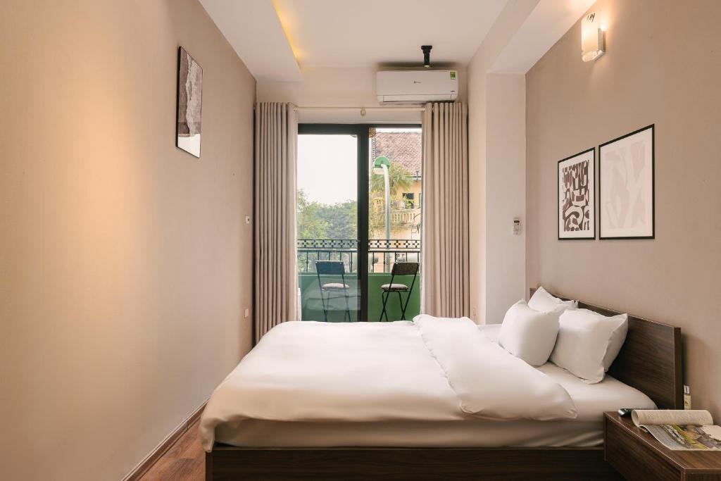 Postel nebo postele na pokoji v ubytování Hanoi-Oi Homestay Cau Go
