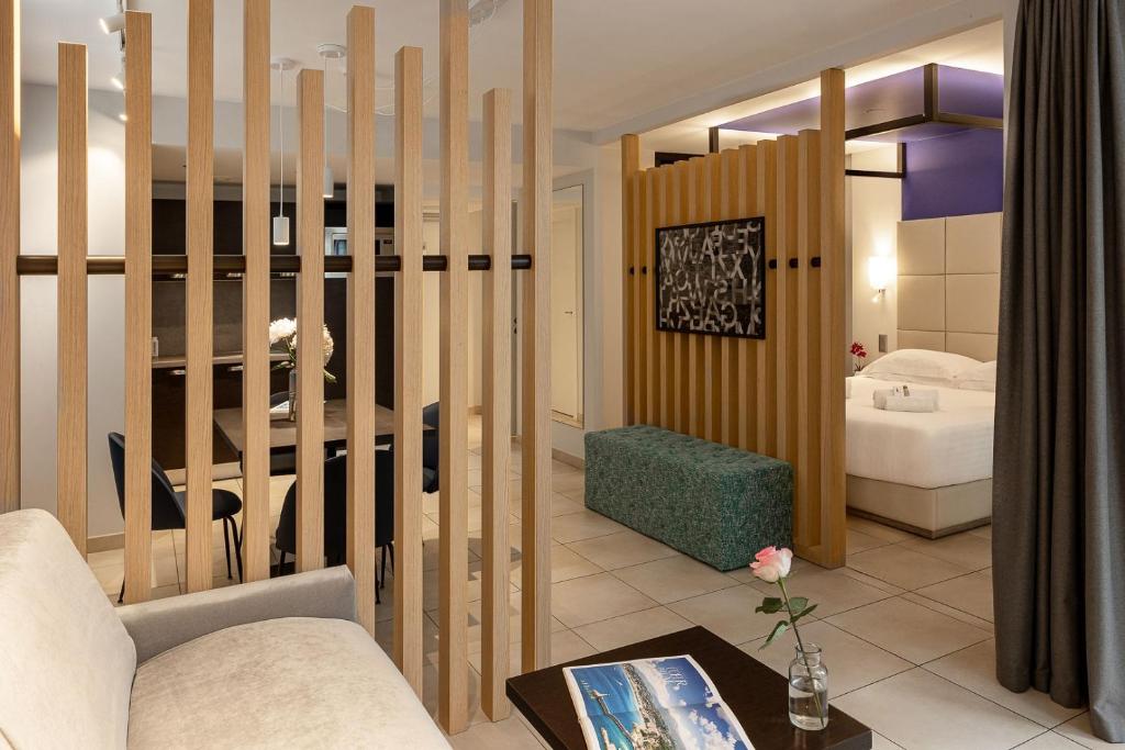 a living room with a couch and a table at Royal Antibes - Luxury Hotel, Résidence, Beach & Spa in Antibes
