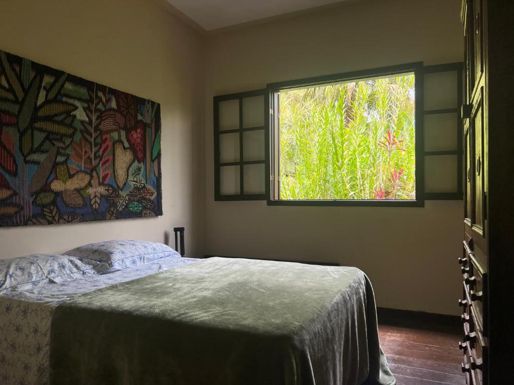 Cama ou camas em um quarto em Refúgio Tranquilo na Natureza com Casa de Festas: Perfeito para Família e Amigos