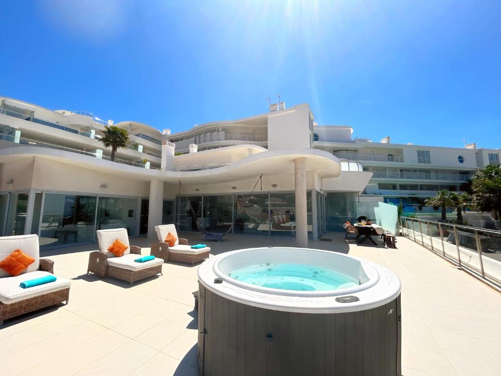 a large building with a hot tub on a patio at Beautiful modern apartement with Jacuzzi, 1 km from the beach in Torremuelle
