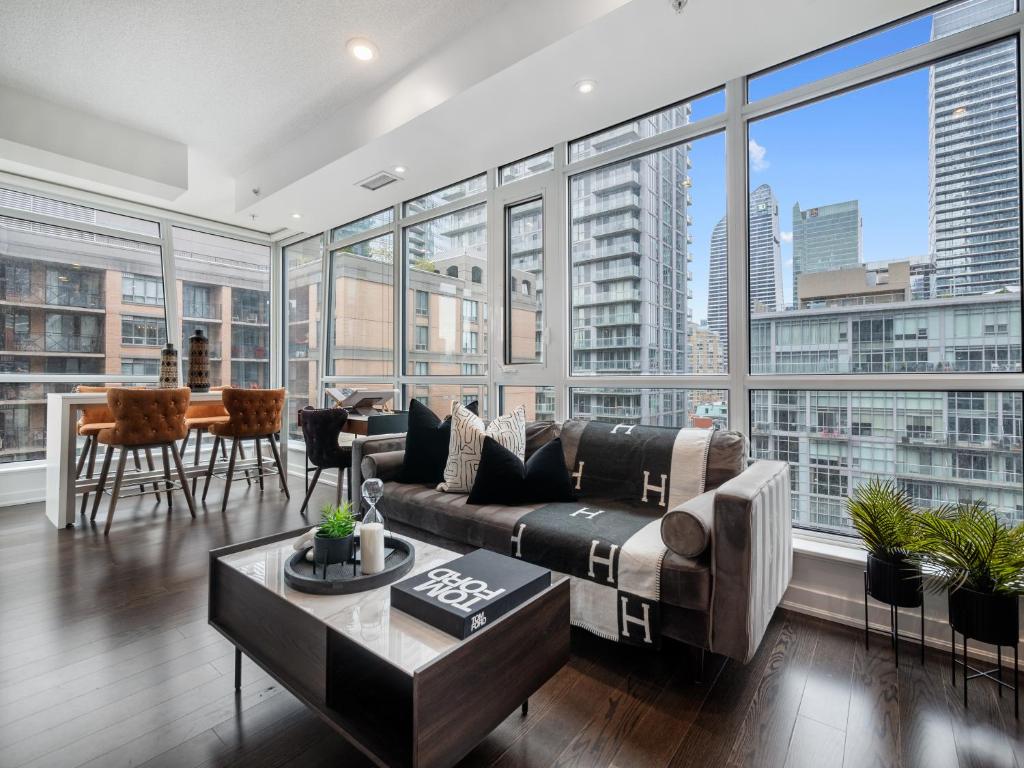a living room with a couch and a table at Designer Two Bedroom Suite. in Toronto