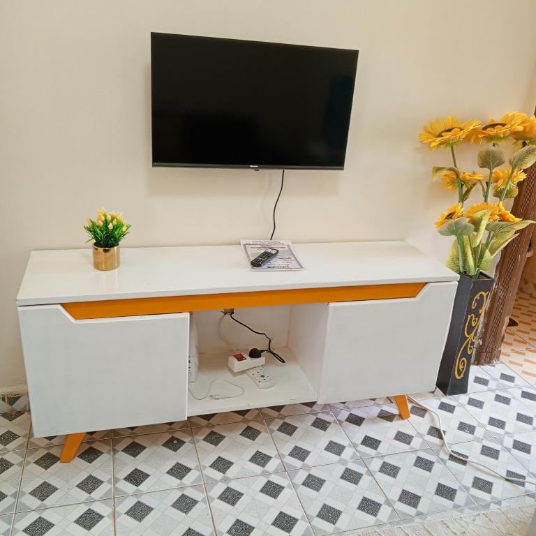 a white desk with a television on a wall at Nakuru Residential and Fully Furnished apartments in Nakuru