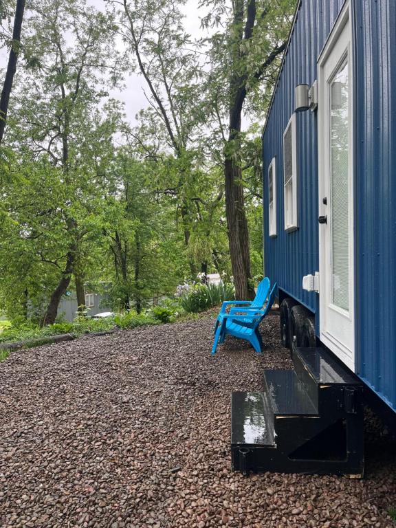 a blue bench sitting next to a blue house at The Overlook Tiny Home in Elizabethtown