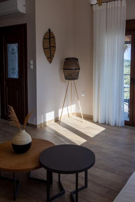 a living room with a coffee table and a table sidx sidx sidx at Koukounaraki Apartment 1 in Skiathos