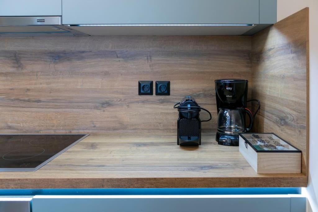 a counter top with a coffee maker and a coffeemaker at Koukounaraki Apartment 1 in Skiathos