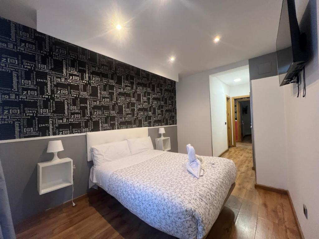 1 dormitorio con 1 cama y pared en blanco y negro en Hostal New Life Madrid, en Madrid
