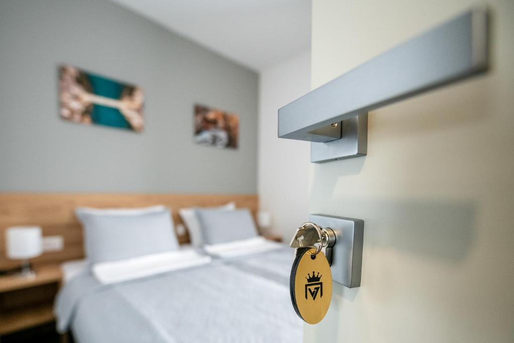 a room with a bed with a tag on the door at Imperial rooms in Mostar