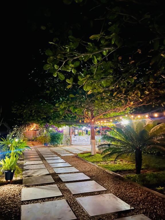 a walkway lit up at night with lights at Chris Espace in Toliara