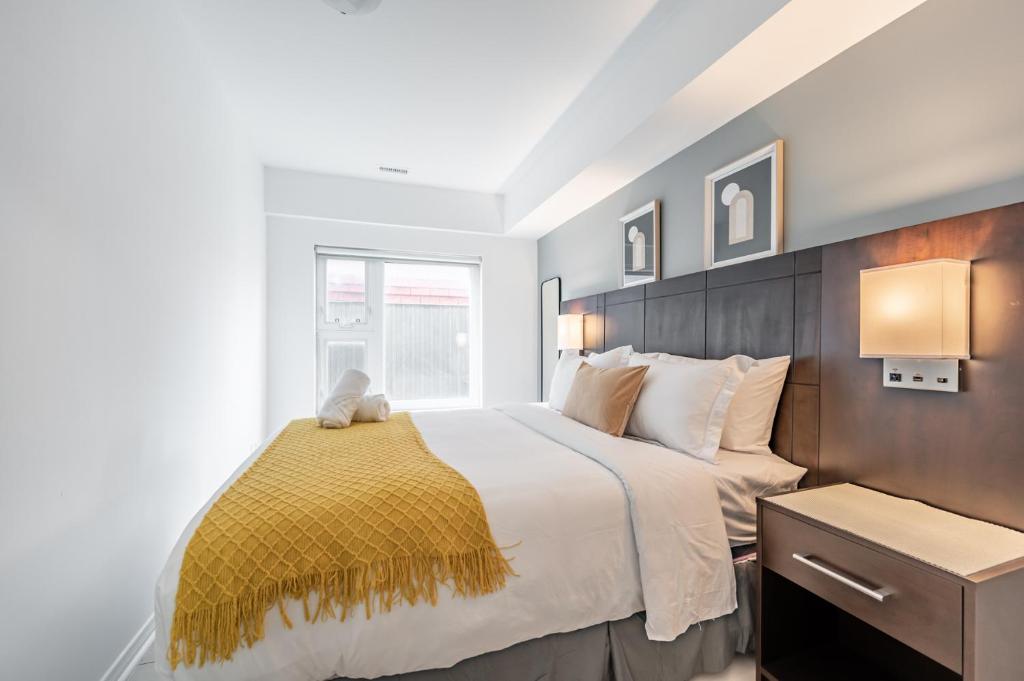 a bedroom with a large bed and a window at Toronto Market Suites in Toronto