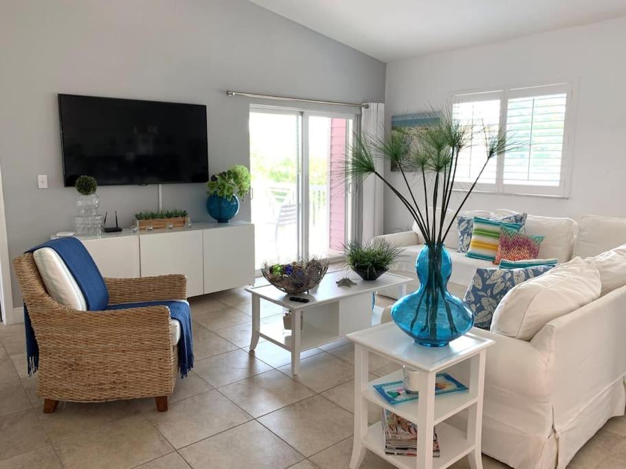a living room with a white couch and a vase on a table at Bimini Blue Villa Villa in Alice Town