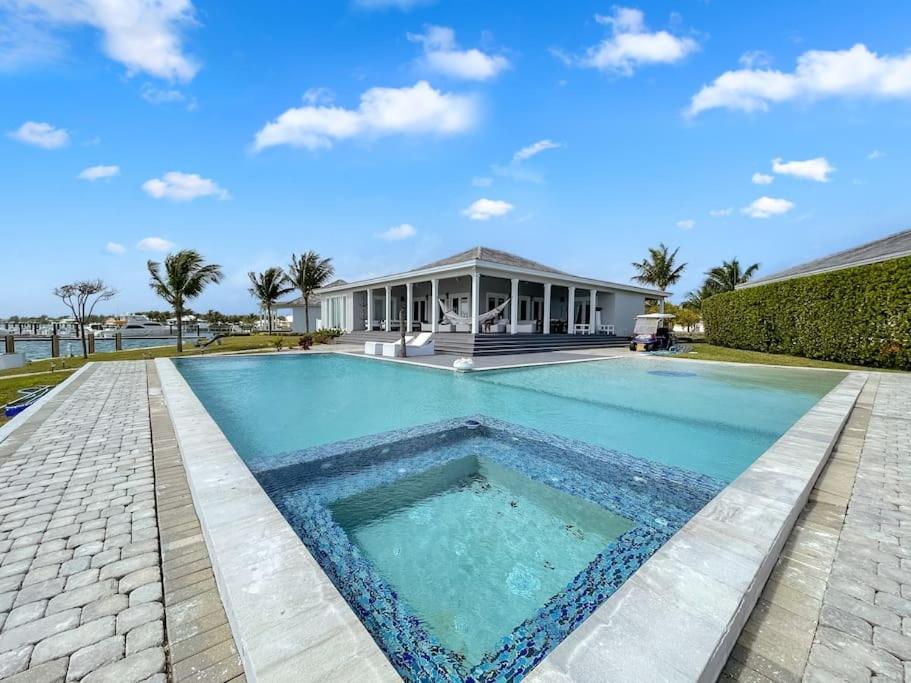 a swimming pool in front of a house at Largest Private Island Home & Pool Villa in Alice Town