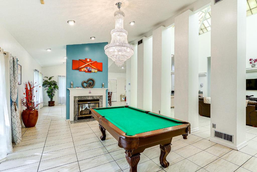 a pool table in a living room with a chandelier at Unique Pet-Friendly Dover Home with Skylight in Dover