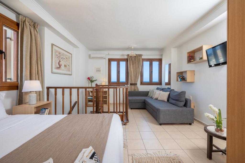 a living room with a bed and a couch at Rocca a Mare Maisonette I in Heraklio Town