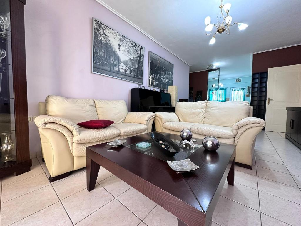 a living room with two couches and a coffee table at Ήσυχο διαμέρισμα στην Ελευσίνα in Elefsina