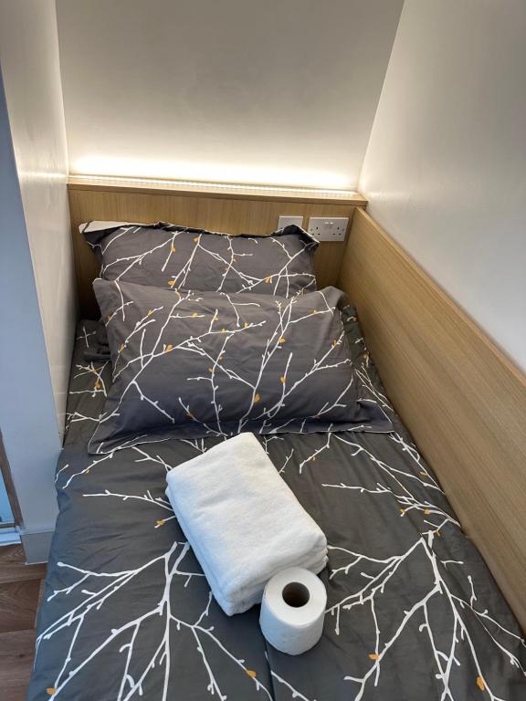 un letto con un rotolo di carta igienica sopra di Not Very Quiet But Best Location a Londra
