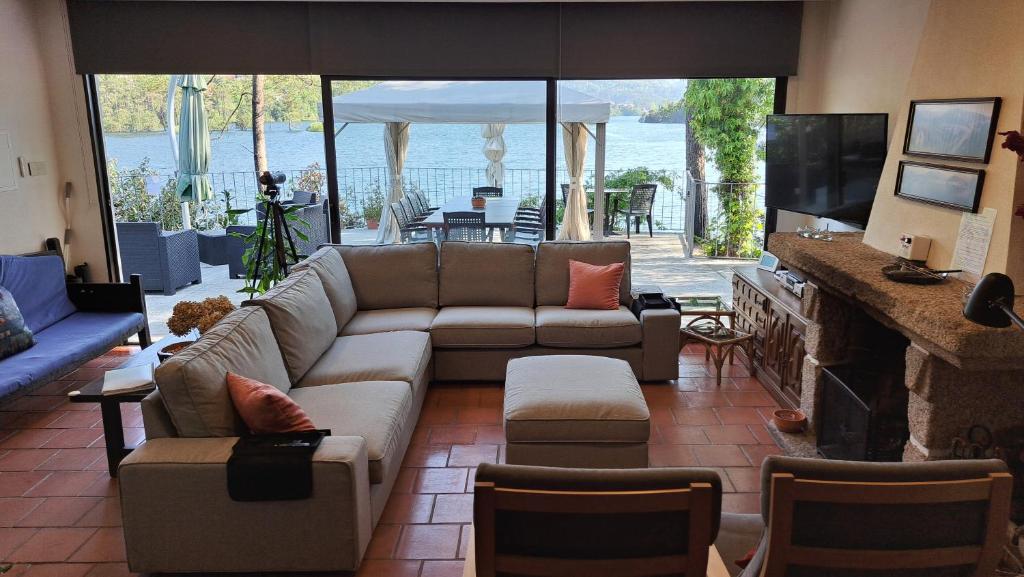 a living room with a couch and a fireplace at Casa do Avô Xico - Gerês Lake House - 10pax in Geres
