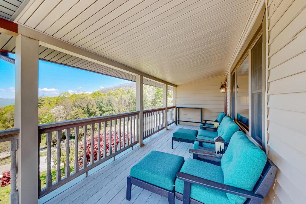 a porch with blue furniture and a large window at Blue Spruce Retreat in Waynesville
