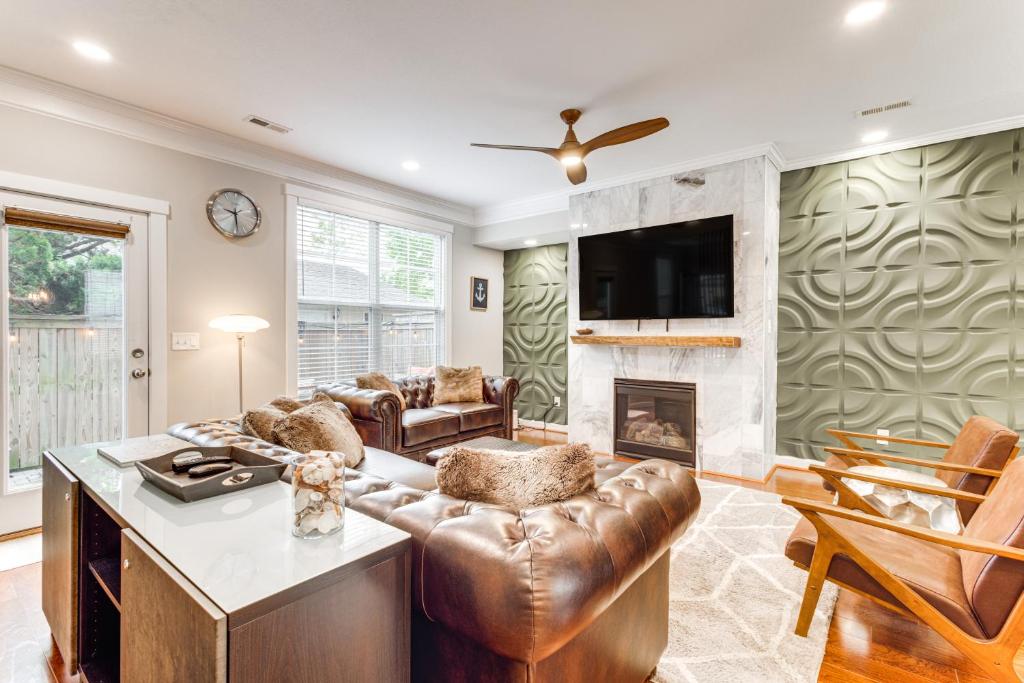 a living room with a couch and a fireplace at Modern Virginia Beach Retreat in Resort District! in Virginia Beach