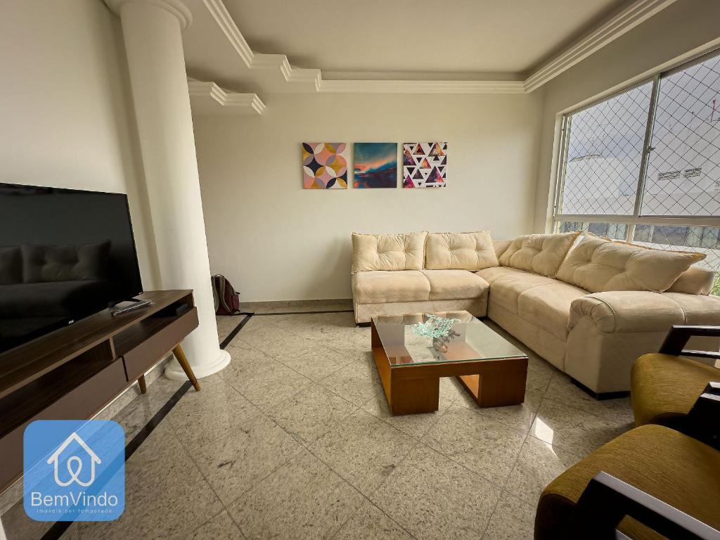 a living room with a couch and a coffee table at Apartamento 2/4 completo e aconchegante em Salvador in Salvador