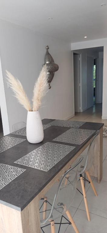 a table with a vase with feathers on it at CHEZ LALLA in Marseille