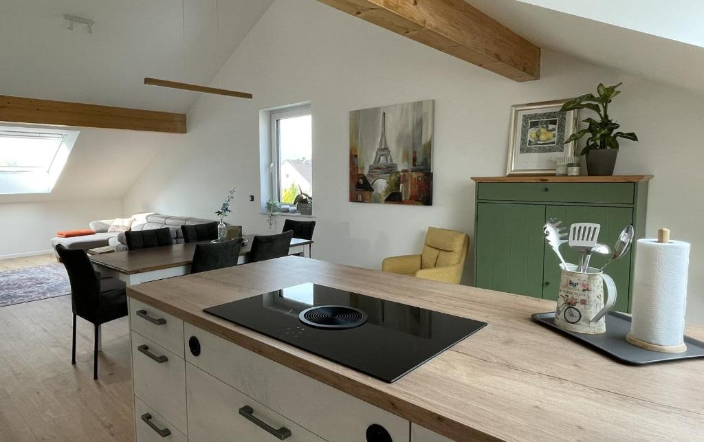 a kitchen with a counter top and a living room at Ferienwohnung Selina in Kripp