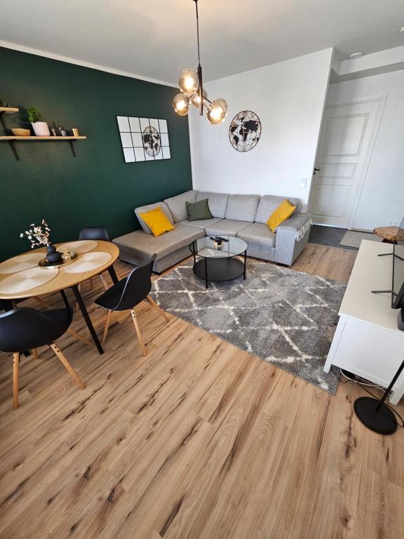 a living room with a couch and a table at CityStation 59m2 Top Floor Sauna Apartment, WiFi in Lahti