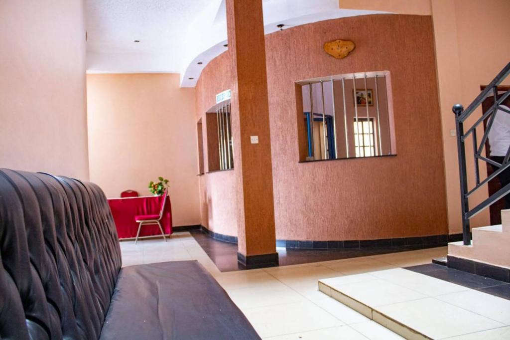 a hallway with a mirror and a red chair at Deka B&B Ksh1500 in Nairobi