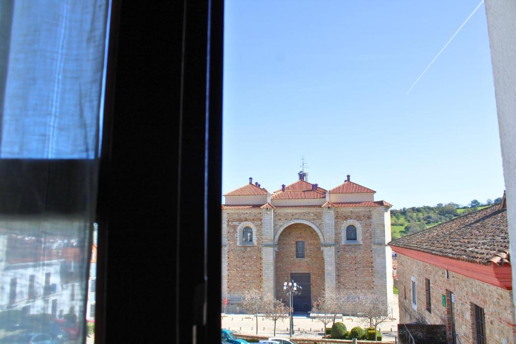 a view of a church from a window at La Casita de la Plaza - ONLY ADULTS by SIERRA VIVA in Aracena