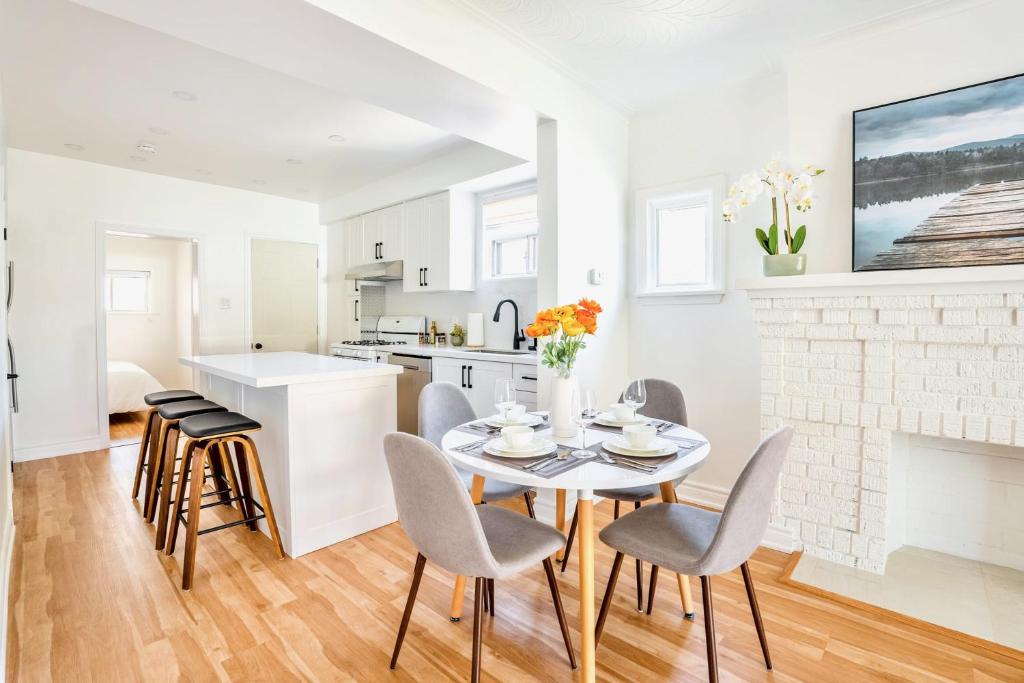 a kitchen and dining room with a table and chairs at Stunning Home with Large Patio Sundeck in Toronto