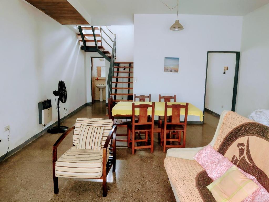 a living room with a table and chairs and a staircase at G Duplex estratégico en ciudad de Mendoza in Mendoza