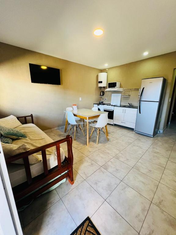 a kitchen and dining room with a table and a refrigerator at DEPTO SOFIA in Junín
