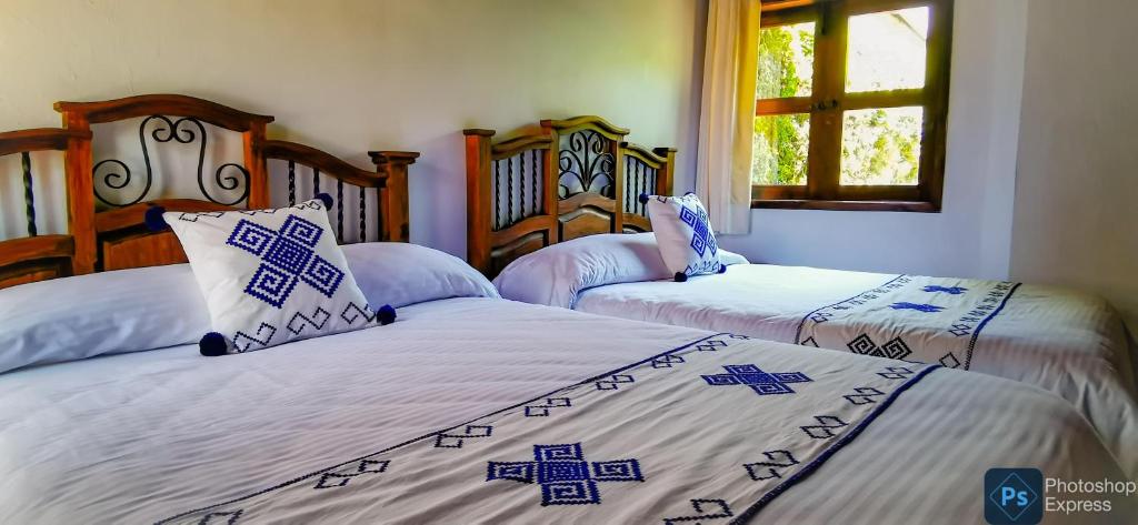 Postel nebo postele na pokoji v ubytování Hotel Ocho Barrios
