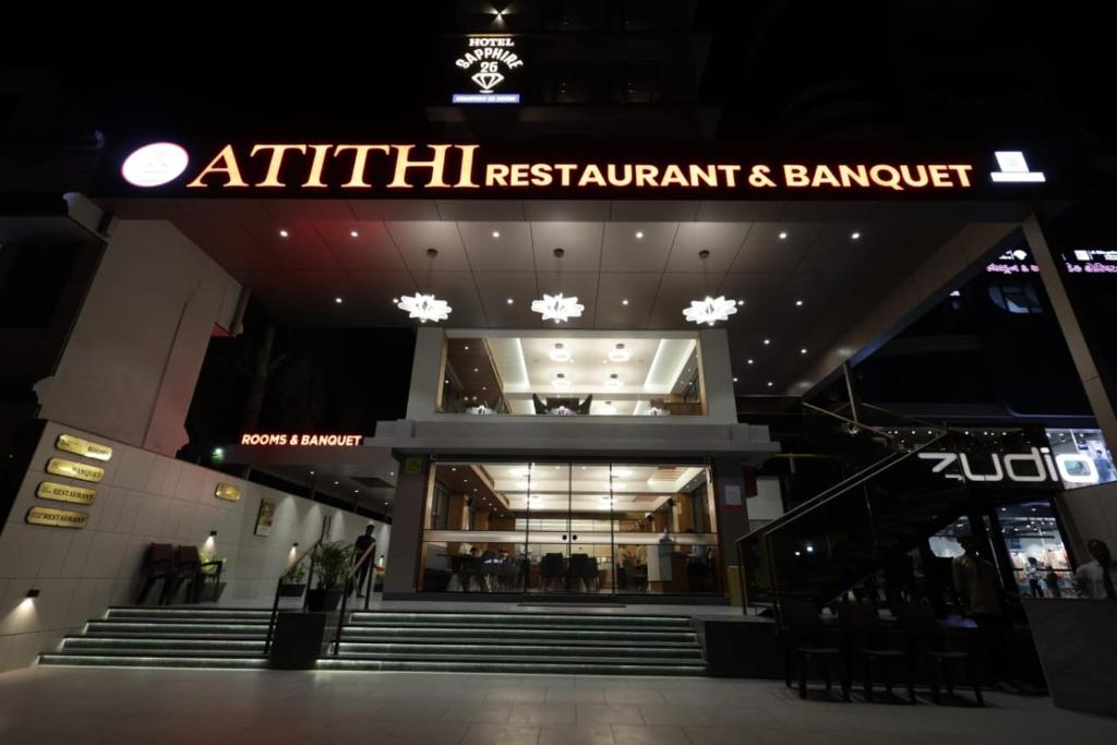 an entrance to a shopping mall at night at Hotel Sapphire 26 in Surat