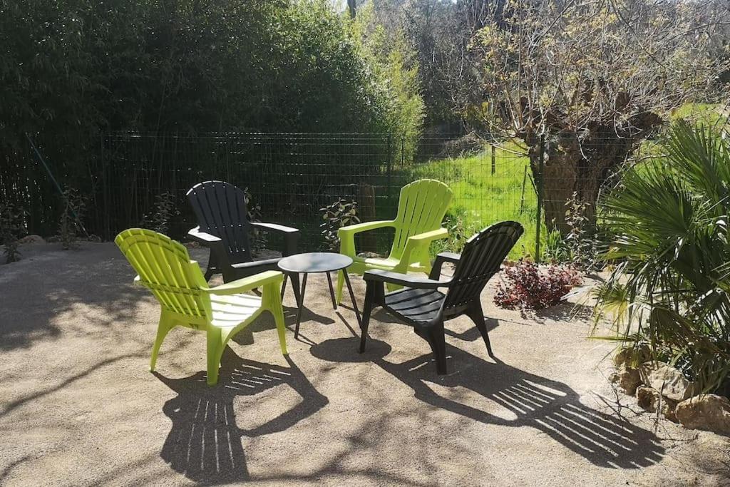 un groupe de chaises et une table sur une terrasse dans l'établissement Gîte L'hirondelle à St Antonin du Var, 2 chambres, à Masseboeuf