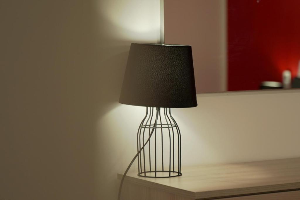 a black lamp sitting on a table in a room at Modern 5-Bedroom Apartment Central Malta in Mosta