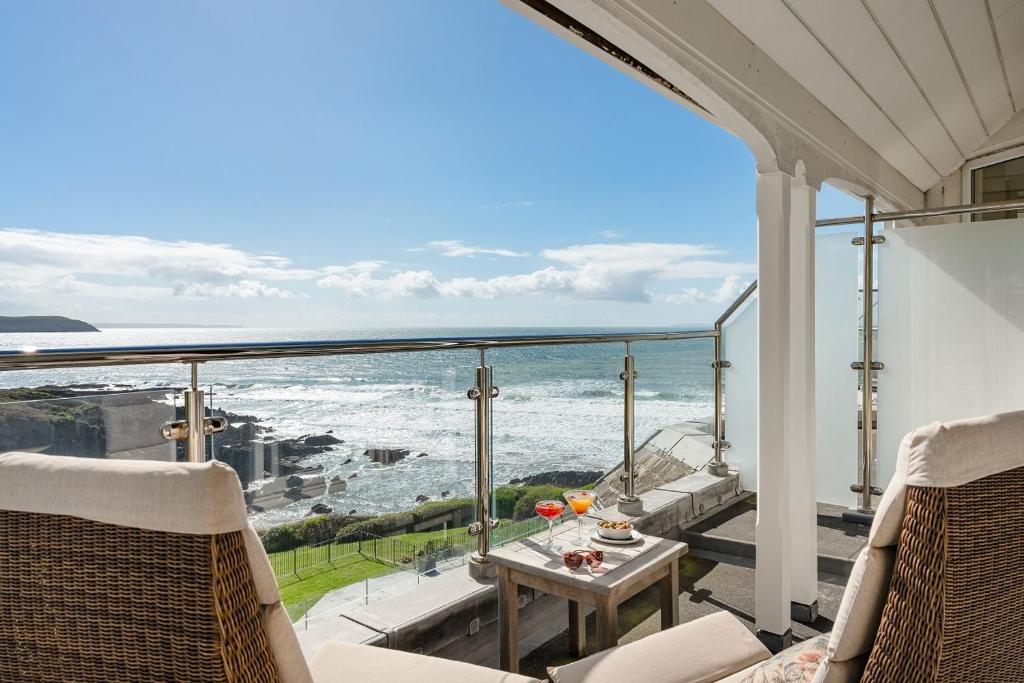 a view of the ocean from the balcony of a house at Watersmeet Hotel in Woolacombe