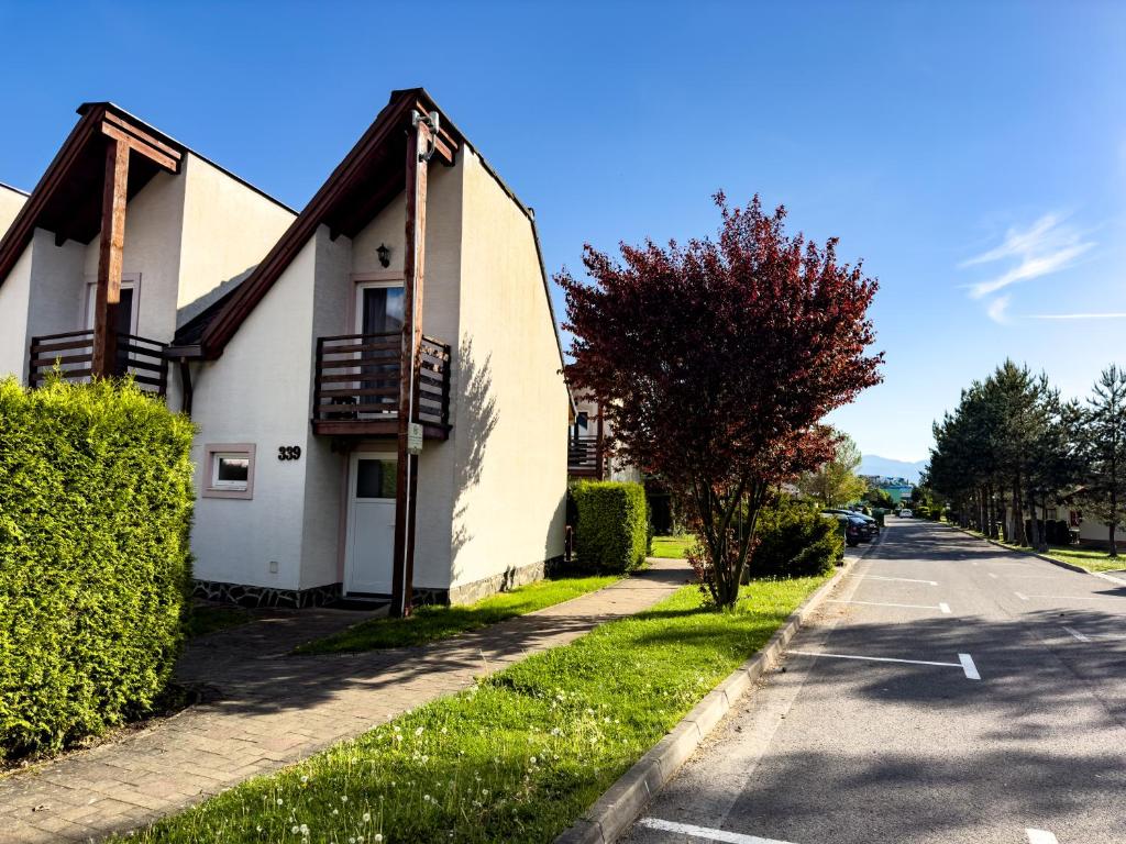 a white house on the side of a street at Apartmán 339 - Tatralandia in Liptovský Mikuláš