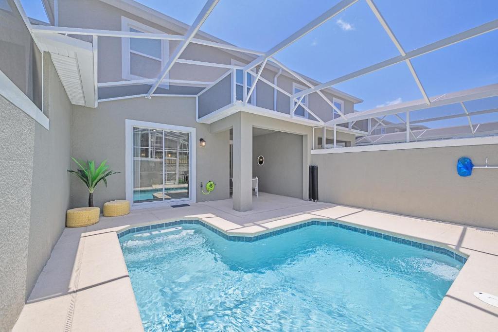a swimming pool in the middle of a house at Upstay - ChampionsGate Home w Private Pool & BBQ in Kissimmee