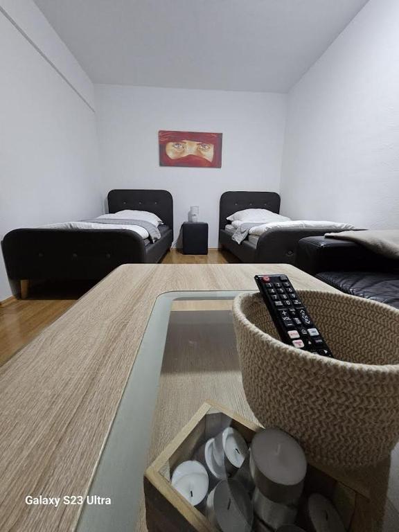 a living room with a table with a remote control at M&L Wohnen 2 in Essen