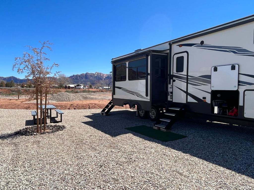 an rv parked in a gravel parking lot at Unique 2 Bedroom Campsite on the backside of Zion in Apple Valley