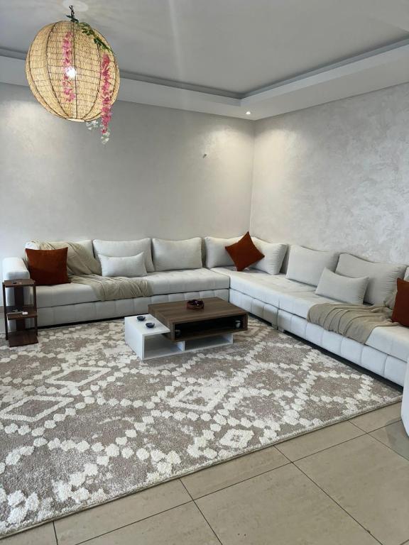 a living room with a couch and a rug at welcome to ur appr in Agadir