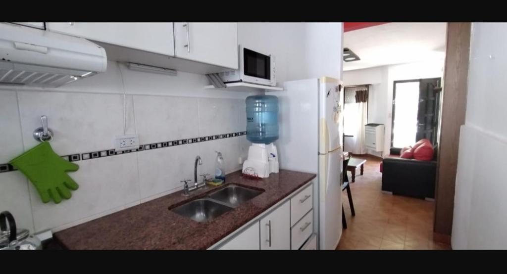 a kitchen with a sink and a counter top at Duplex Olivia in San Clemente del Tuyú
