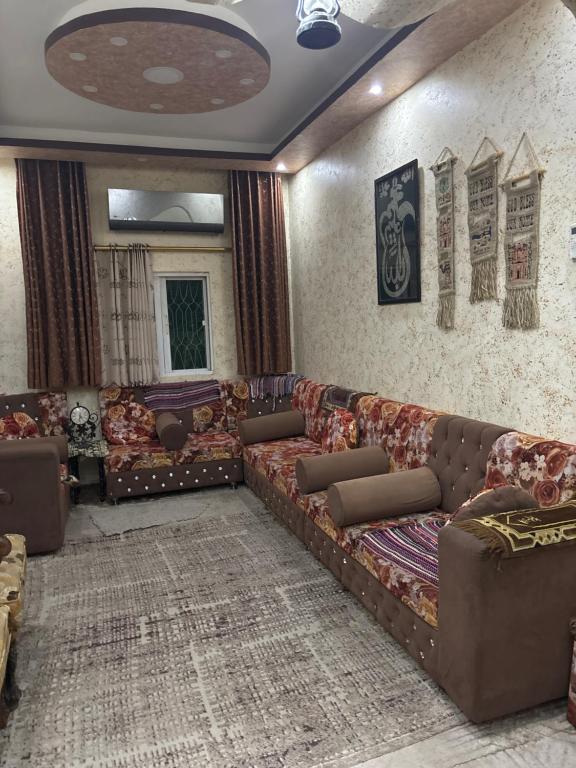 a living room with couches and a rug at شقق ايلين 