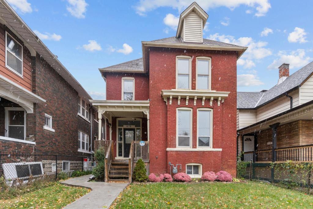 a red brick house with a tower at 3 bedroom with laundry and parking at Windsor in Windsor