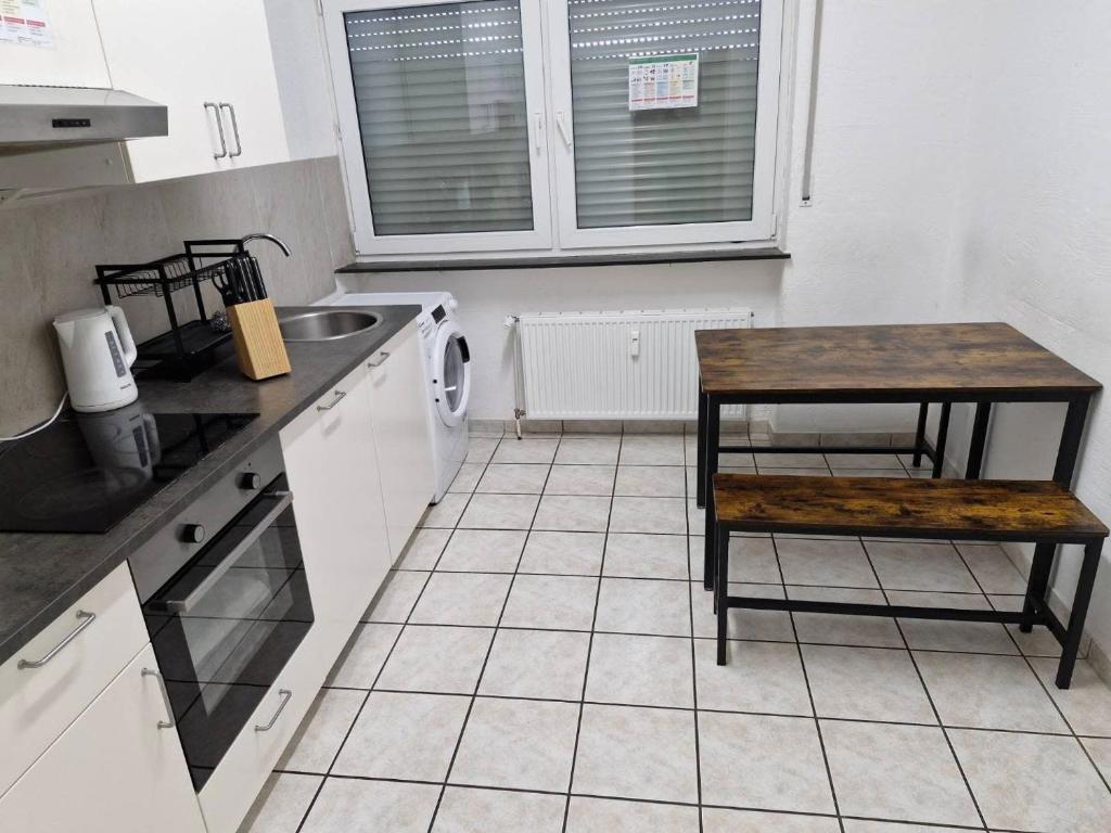 a kitchen with a table and a sink and a table at L8 Street - Mühlacker in Mühlacker