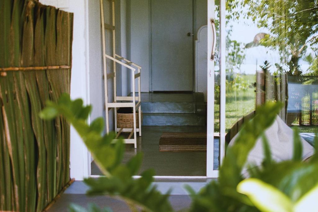 a door leading to a porch with a staircase at Calma - Surf, Yoga & Coffee on a Private Beach in Dickwella